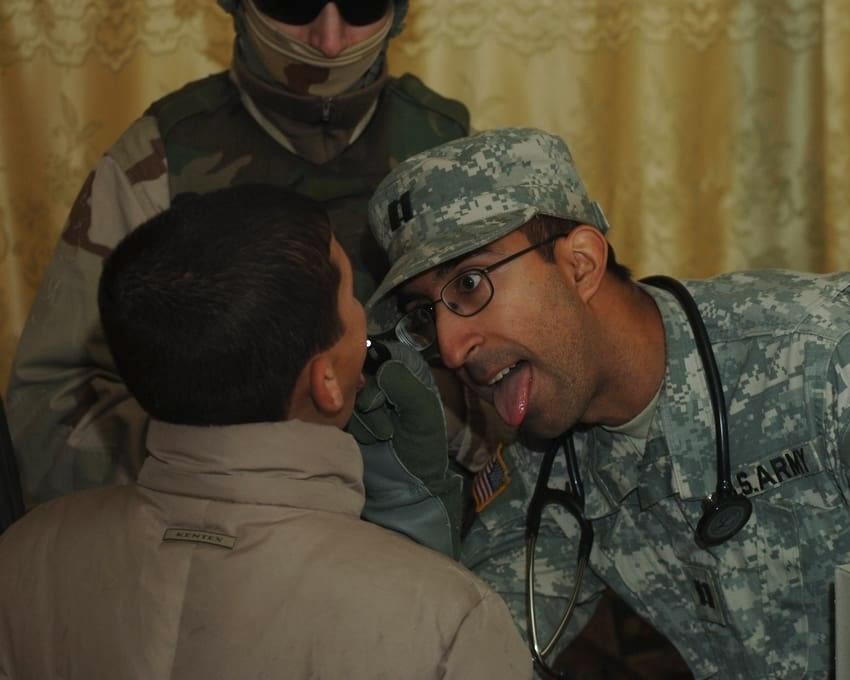Major Beezer Moolji examining a child during his U.S. Army deployment in Iraq, January 5, 2007