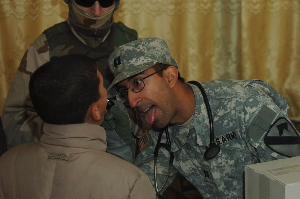 Captain Beezer Moolji examining a child during his deployment in Iraq, January 5, 2007
